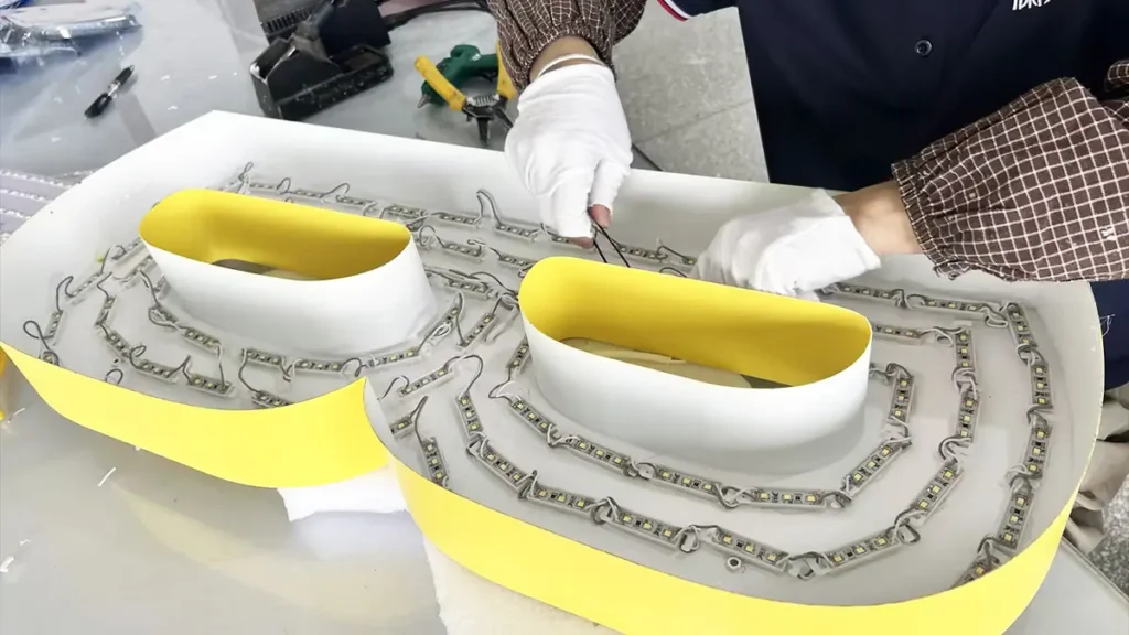 LED modules positioned inside reverse channel letters during assembly